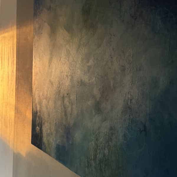 Morning Light Warm morning light cutting across a textured abstract painting in a dark hallway, creating strong contrast between light and shadow, by Susan Lobb Porter