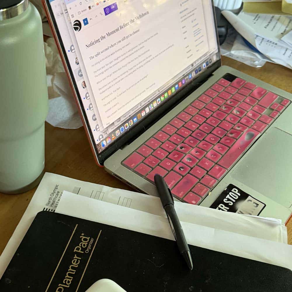 kitchen table desk Cluttered kitchen table workspace with laptop, planner, and notes during a busy moment, capturing the feeling before an emotional reaction