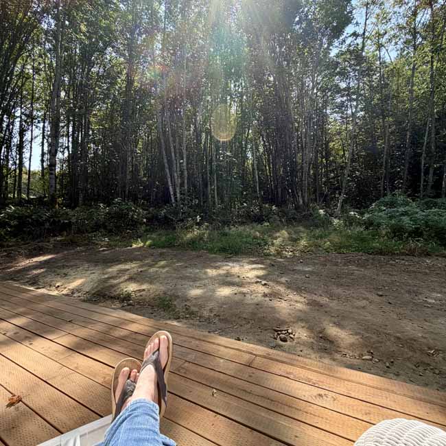 Putting Down Roots Feet resting on the new studio deck overlooking the woods in Port Angeles