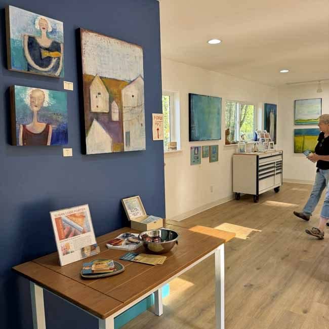 Visitor looking at abstract paintings displayed in my Port Angeles studio during Open Studios.