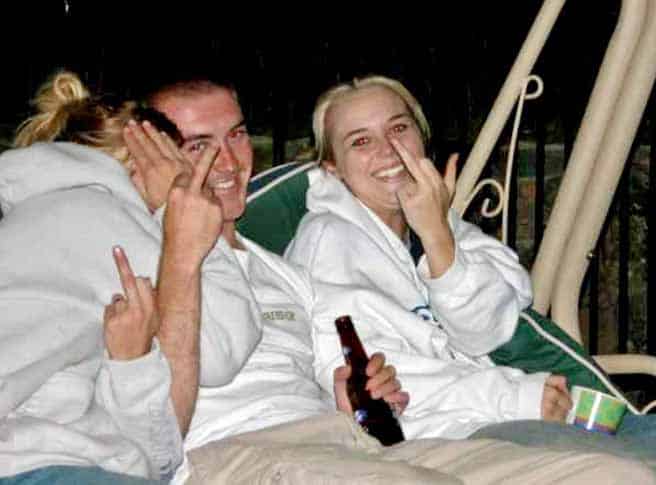 Take the Damn Picture family photo Three family members laughing and making rude gestures at the camera during a casual gathering.